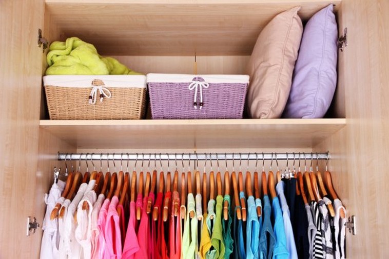 depositphotos 43868787 stock photo colorful clothes hanging in wardrobe