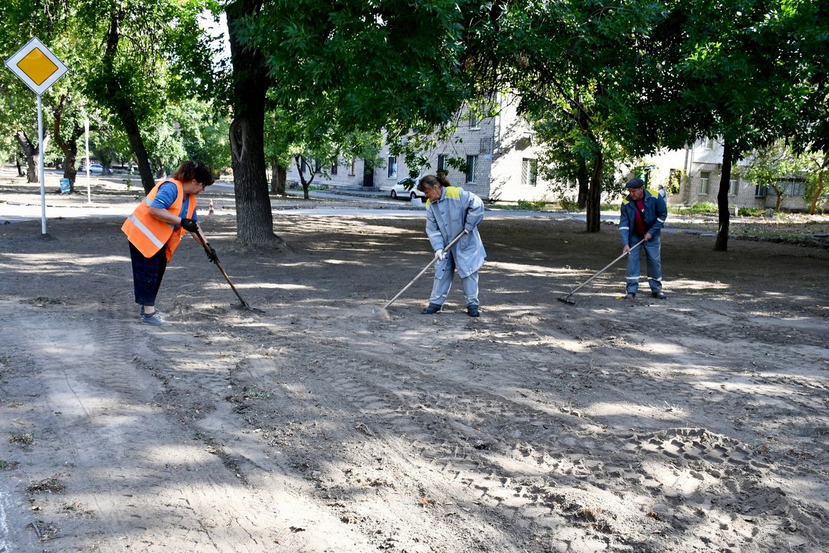 Попри обстріли у Нікополі комунальники ремонтують дороги, планують ґрунт, прибирають вулиці (фото)